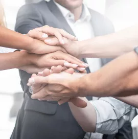 Close up view of young business people putting their hands together. Stack of hands. Unity and teamwork concept.